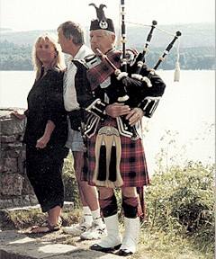 bagpiper with tourists