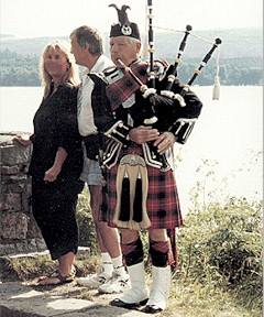 bagpiper with tourists